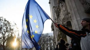 LONDON, ENGLAND - DECEMBER 05: A man waves the EU flag in front of the Supreme Court ahead of the first day of a hearing into whether Parliament's consent is required before the Brexit process can begin, on December 5, 2016 in London, England. The eleven Supreme Court Justices will hear the government's appeal, following the High Court's recent decision that only Parliament can trigger Article 50. (Photo by Leon Neal/Getty Images)